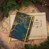 A notebook with a map of Middle Earth on the cover is placed on top of other maps, with leaves and branches framing the scene. Produktbild-Vorschau
