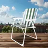 A striped camping chair is set up on a wooden deck with a garden and houses in the background under a blue sky with clouds. Anteprima dell’immagine prodotto