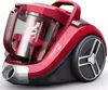 A red bagless cylinder vacuum cleaner shown from a three-quarter front-left angle on a white background. Voir les images du produit