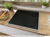 A modern kitchen countertop with an induction hob and a pot of food. Anteprima dell’immagine prodotto