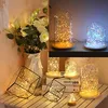 A collage of decorative string lights in various settings, including glass domes and geometric holders, with a vase of flowers on the left. Produktbild-Vorschau