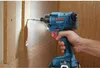 A hand holding a Bosch impact driver, drilling into a wooden surface. Anteprima dell’immagine prodotto