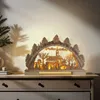 A wooden Christmas decoration with lights is displayed on a dresser. Náhľad obrázku produktu