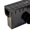 A close-up, angled view of a black plastic drainage channel with a grate on top and a pipe outlet on the side, set against a white background. Anteprima dell’immagine prodotto