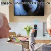 Two elderly people are sitting on a couch, one holding a remote control and pointing it towards a TV. Produktbild-Vorschau