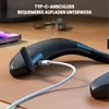 A close-up shot of a black neck speaker being charged with a white USB-C cable on a brown surface. Produktbild-Vorschau
