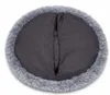 The underside of a round pet bed with a fluffy gray border and a dark gray fabric center with a zipper. Produktbild-Vorschau