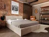 A bedroom with a bed, chair, and shelving unit. Produktbild-Vorschau