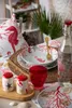 A table setting with a nautical theme, featuring plates, bowls, salt and pepper shakers, and a bottle of water. Voir les images du produit