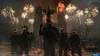 A group of soldiers stand in front of a burning church with fireworks in the background. Produktbild-Vorschau