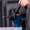 A person is holding a blue and black power drill with a drill bit extended. Produktbild-Vorschau