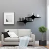 A living room scene with a sofa, shelves, and a plant. Anteprima dell’immagine prodotto