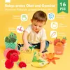 A baby playing with a set of plush fruit and vegetable toys. Produktbild-Vorschau