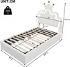A white single bed with a crown-shaped headboard with LED lighting. Produktbild-Vorschau