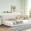 A bedroom scene featuring a beige upholstered daybed with pillows and blankets. Produktbild-Vorschau