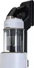 A close-up shot of a white and black Samsung stick vacuum cleaner mounted on a wall charging dock. Voir les images du produit