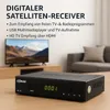 A digital satellite receiver is placed on a wooden table in front of a television and a sofa. Produktbild-Vorschau
