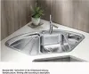 A stainless steel corner sink with a faucet and a small plant in a pot on a white countertop. Podgląd zdjęcia produktu