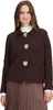 A woman wearing a brown cardigan and skirt, posing against a white background. Produktbild-Vorschau