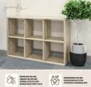A wooden shelving unit with six compartments, next to a potted plant. The image also includes instructional text and icons at the bottom. Produktbild-Vorschau