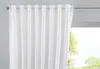 A white curtain hangs in front of a window with trees visible outside. Produktbild-Vorschau