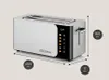 A studio shot of a silver and black toaster with dimensions indicated by measurement lines and circles. Voir les images du produit