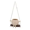 A hanging planter shaped like a round character with a smiley face, sitting on a swing. Anteprima dell’immagine prodotto