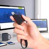 A hand holds a black USB hub in front of two computer monitors and a laptop. Anteprima dell’immagine prodotto