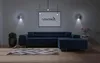 A modern living room with a large sectional sofa, rug, and artwork on the wall. Produktbild-Vorschau