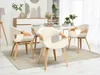 A dining room setting with a round table and chairs. Produktbild-Vorschau
