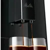 A close-up shot of a black Melitta coffee machine dispensing coffee into two glasses. Voir les images du produit