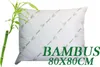 A white pillow with green bamboo leaf patterns and text overlay. Produktbild-Vorschau