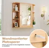A wooden bathroom cabinet with a mirror and shelves is mounted on a white paneled wall. A close-up inset shows a screw and wall plug used for installation. Náhled obrázku produktu