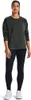 A woman is standing and modeling a dark green sweatshirt and black leggings. Produktbild-Vorschau