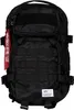 A black tactical backpack with a red "Remove Before Flight" tag. Produktbild-Vorschau