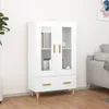 A white highboard with glass doors and drawers, displayed in a room setting with a sofa and a plant. Voir les images du produit