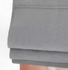 A close-up view of a folded gray linen roman shade. Produktbild-Vorschau