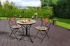 A mosaic bistro set with two chairs and a table on a wooden deck, surrounded by a garden. Podgląd zdjęcia produktu