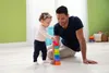 A father and daughter are playing with stacking cups on the floor. Produktbild-Vorschau