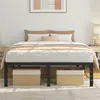A bed frame with a mattress and bedding, set up in a bedroom with nightstands and artwork on the wall.