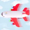 A toy airplane flying in a sky with clouds. Produktbild-Vorschau