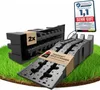 Two black car ramps are shown on a grassy surface, with a promotional badge in the upper right corner. Produktbild-Vorschau
