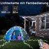 A tent set up in a yard at night, decorated with string lights, with two children inside. Produktbild-Vorschau