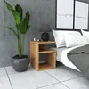 A bedside table next to a bed with two framed prints on the wall. Produktbild-Vorschau