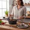 A woman is cooking in a kitchen, stirring a pot on a wooden countertop. Náhľad obrázku produktu