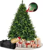 A Christmas tree with gifts at its base and a storage bag.