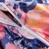 A close-up view of a zipper on a floral patterned fabric. Náhled obrázku produktu