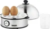 A close-up view of an egg cooker with two eggs on top, a measuring cup, and the lid removed. Produktbild-Vorschau