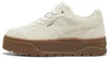 A side view of a cream-colored Puma sneaker with a brown platform sole. Produktbild-Vorschau