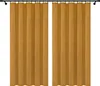Two yellow velvet curtains hanging on a curtain rod against a white background. Produktbild-Vorschau